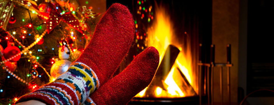 relax in front of an open fire in a christmas cottage